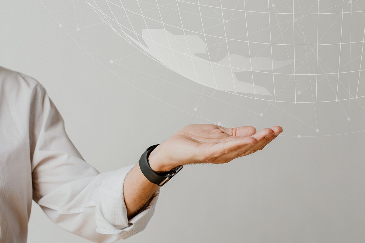Hand holding a digital globe representing technology investments